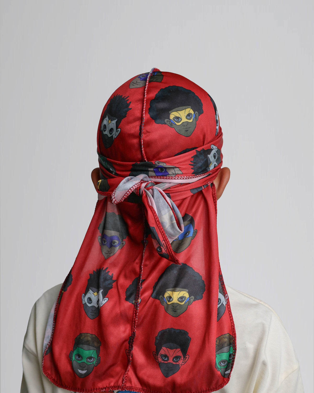 Back view of the red MY HERO kids satin durag showing the tied tails and superhero print